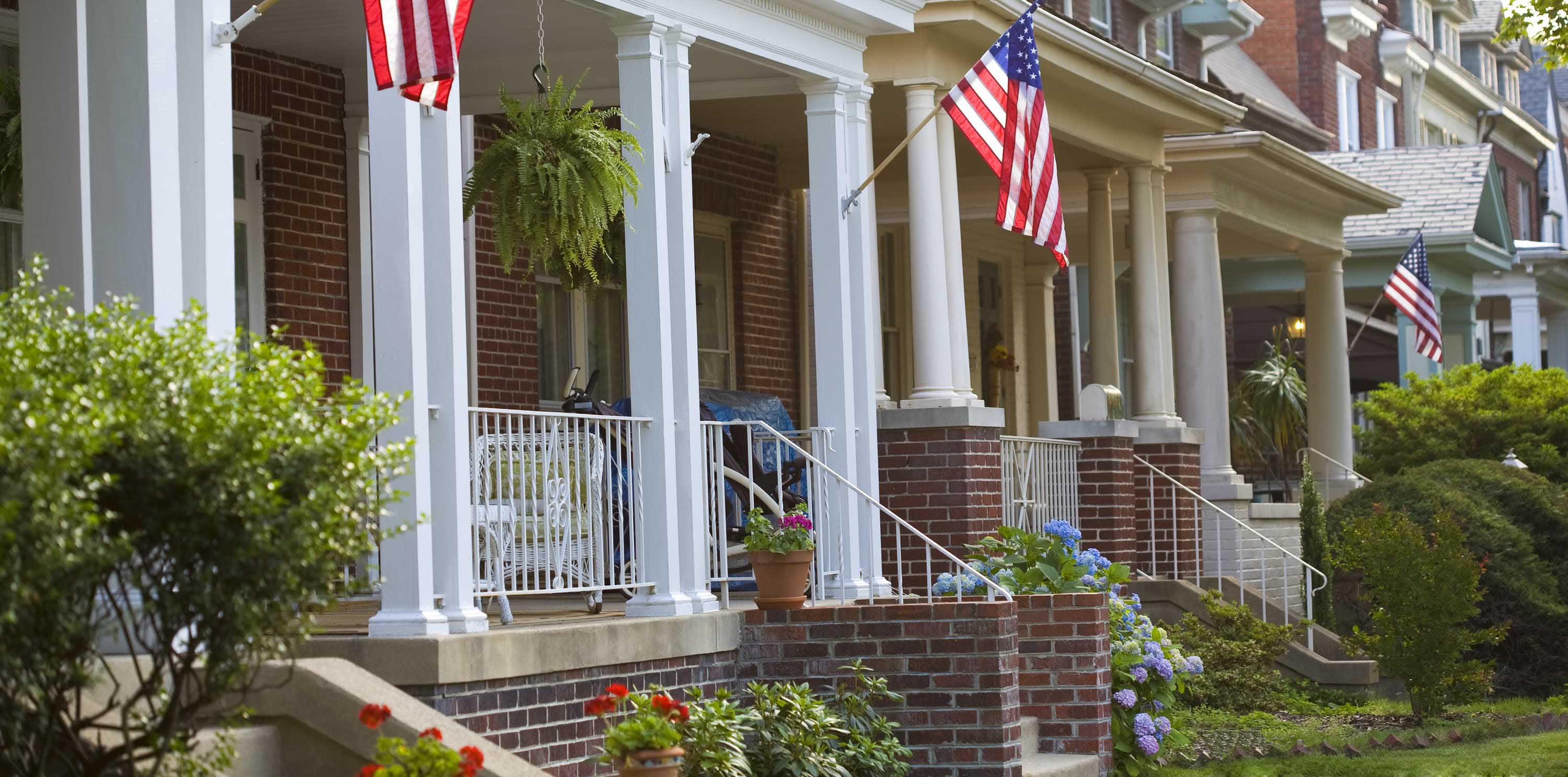 veteran owned homes with american flags waving