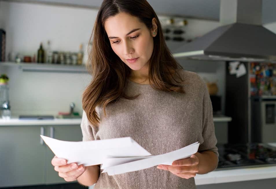 woman looking at bills