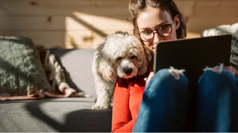 woman with dog researching mortgage interest rates