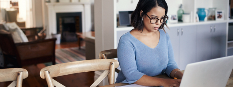 Woman researching mortgage refinance options on computer
