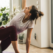 woman doing yoga in sunny room