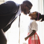 dad kissing daughter goodbye in new home