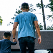 father and son holding hands in new backyard