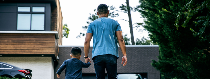 father and son holding hands in new backyard