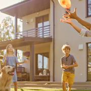 family playing frisbee in new backyard