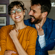 couple smiling with keys to new home