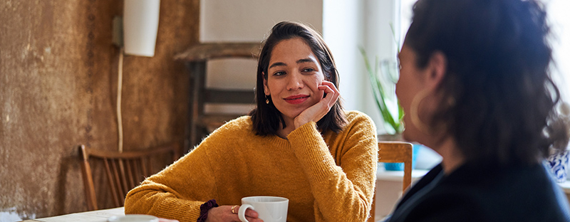 woman talking with realtor about making an offer on a home