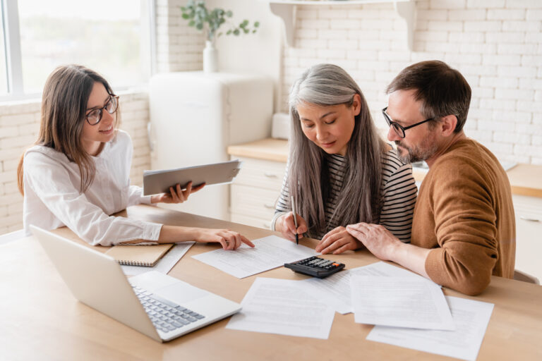 An advisor talks with a couple about qualifying for a mortgage.