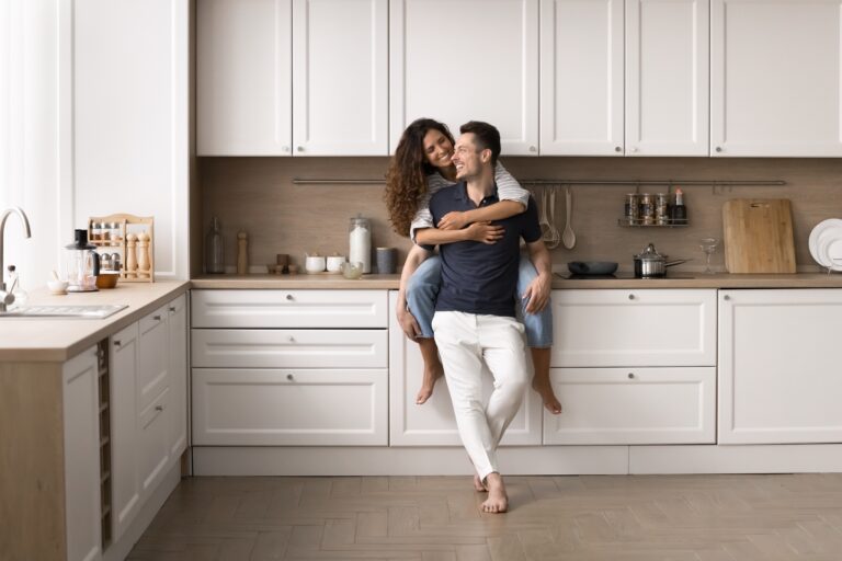 happy couple enjoying newly remodeled home kitchen